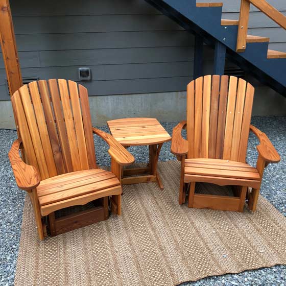 a pair of handmade adirondack glider chairs