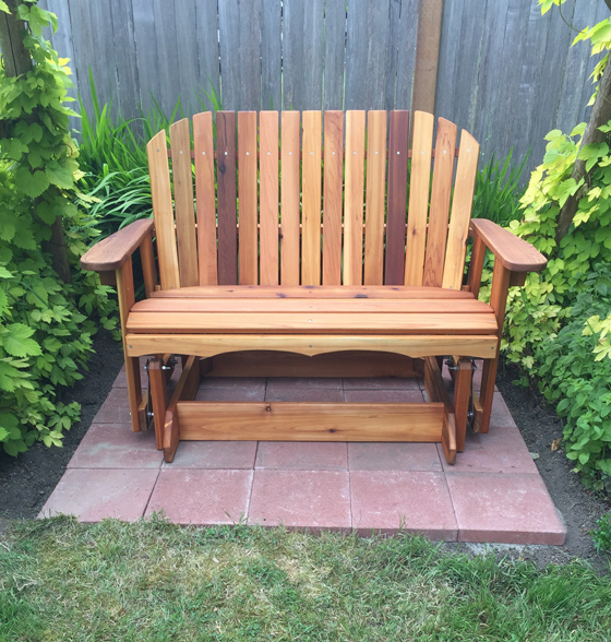 handcrafted garden glider bench in the backyard